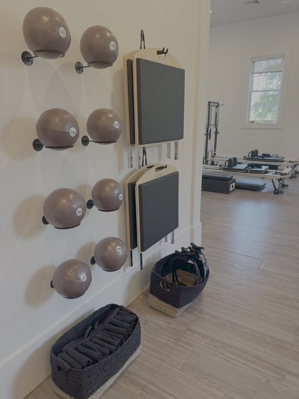 Pilates equipment wall and studio floor at Rose Pilates